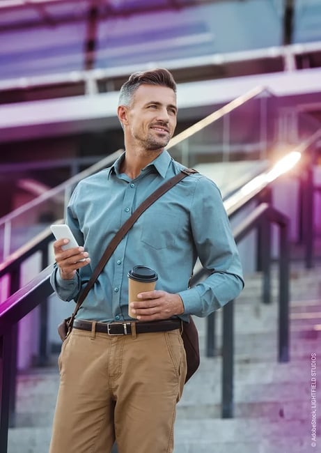 Man with smartphone and coffee mug