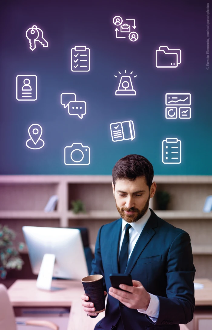 A businessman looking at his smartphone and holding a coffee cup while all COREDINATE function icons hover above him.